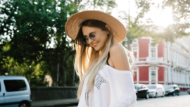 Woman outside sunglasses and hat